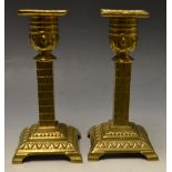 A pair of William Tonks brass candlestic