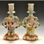 A pair of continental figural candlestic