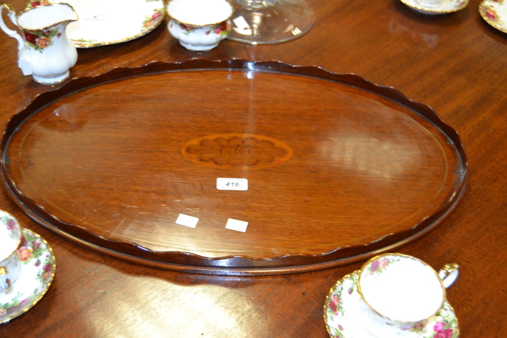 An Edwardian mahogany oval gallery tray,