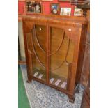 An Art Deco display cabinet, c.1930; a 1940's serpentine fronted display cabinet. (2)