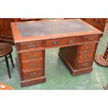 An Edwardian mahogany pedestal desk, leather inlaid top, an arrangement of nine drawers.
