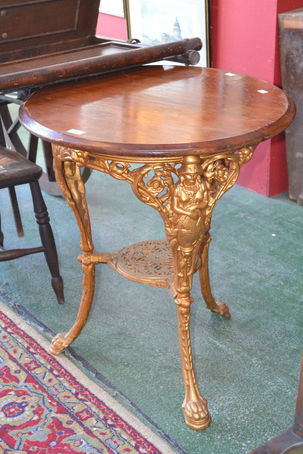 A cast iron circular tavern table, Britannia base