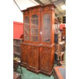 Mahogany break front bookcase, outswept cornice, three arched glazed panel doors over three arched