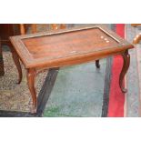 A mahogany coffee table, recessed quarter veneered flame mahogany top with floral carved border,