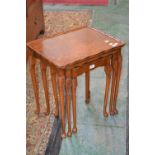A nest of three tables, quarter veneered walnut serpentine rectangular top, cabriole supports,