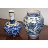 An oriental blue and white ovoid vase; another, slender top, melon shaped vented vase (2)