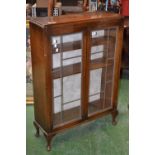 An oak china display cabinet.