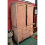 A Victorian stripped pine linen press, two folded panel doors enclosing slides, two short drawers