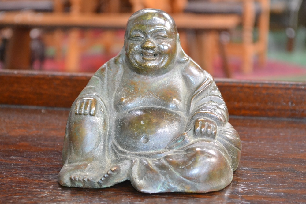 Chinese School, a bronze, of the rotund Buddha, seated, smiling, verdigris patination, 13.5cm wide