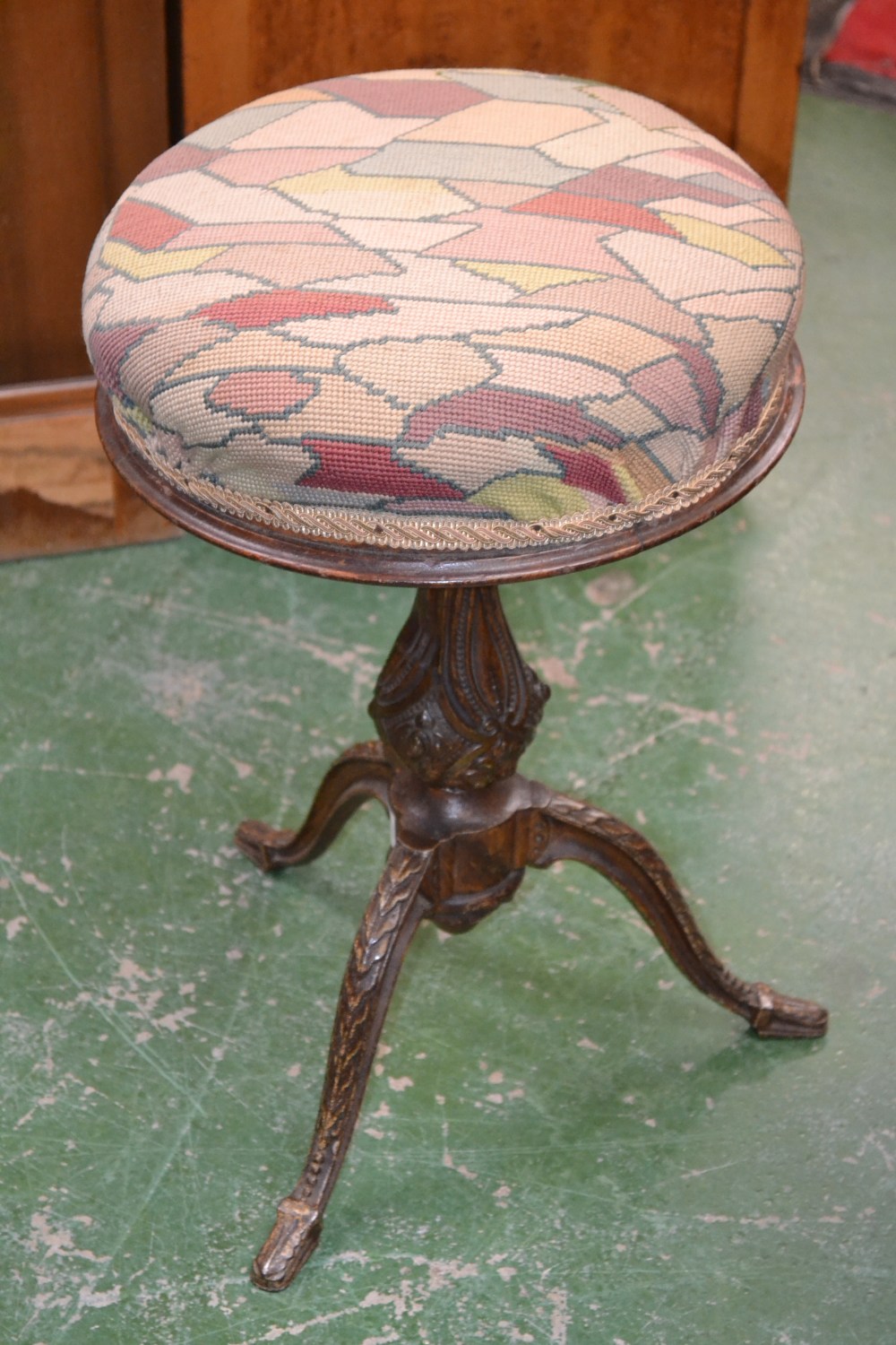 A Victorian cast iron adjustable piano stool, padded circular seat, baluster column, cabriole