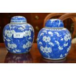 Two blue and white ginger jars and covers, decorated with flowering prunus