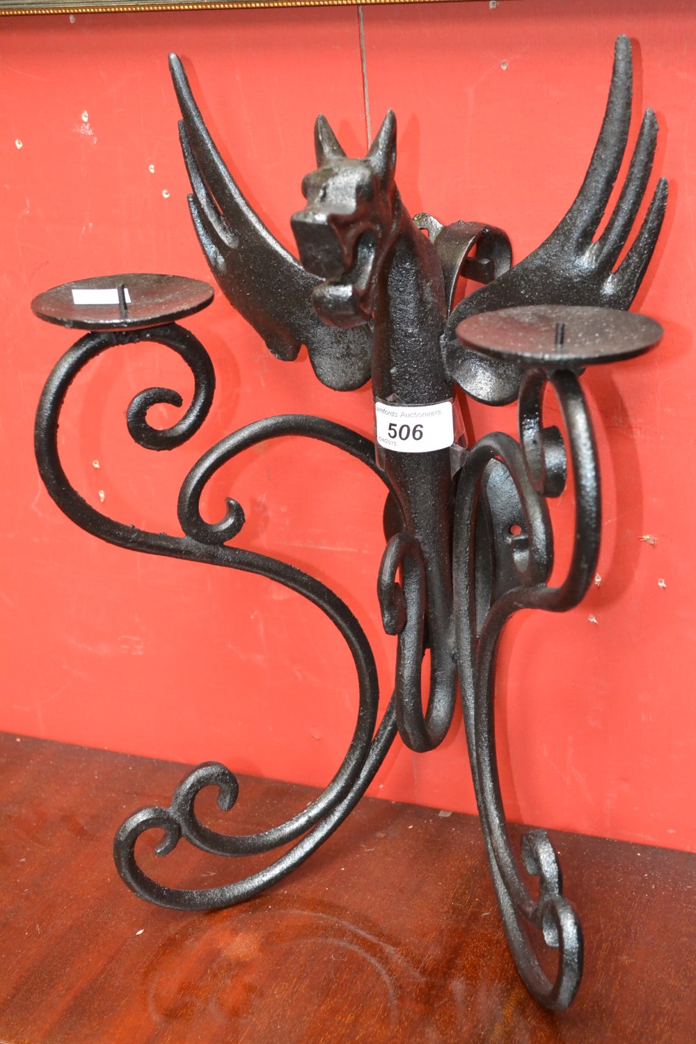 A cast iron two branch dragon wall sconce