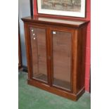 An early 20th century mahogany bookcase, stepped cornice, two glazed doors, plinth base.107cm high