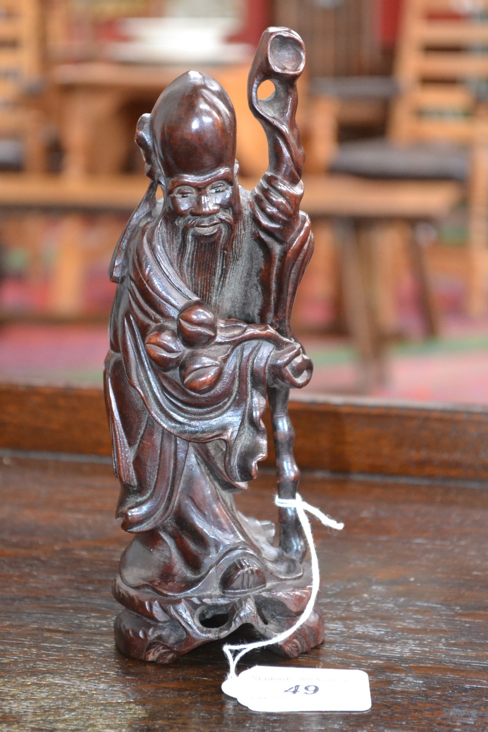 A Chinese hardwood carving, of Shou Lou, he stands, with rugged staff and peaches, 21cm high, early