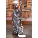 A Chinese hardwood carving, of Shou Lou, he stands, with rugged staff and peaches, 21cm high, early