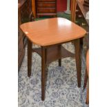 A 1950s kitchen table of small proportions, rounded square top, undertier shelf