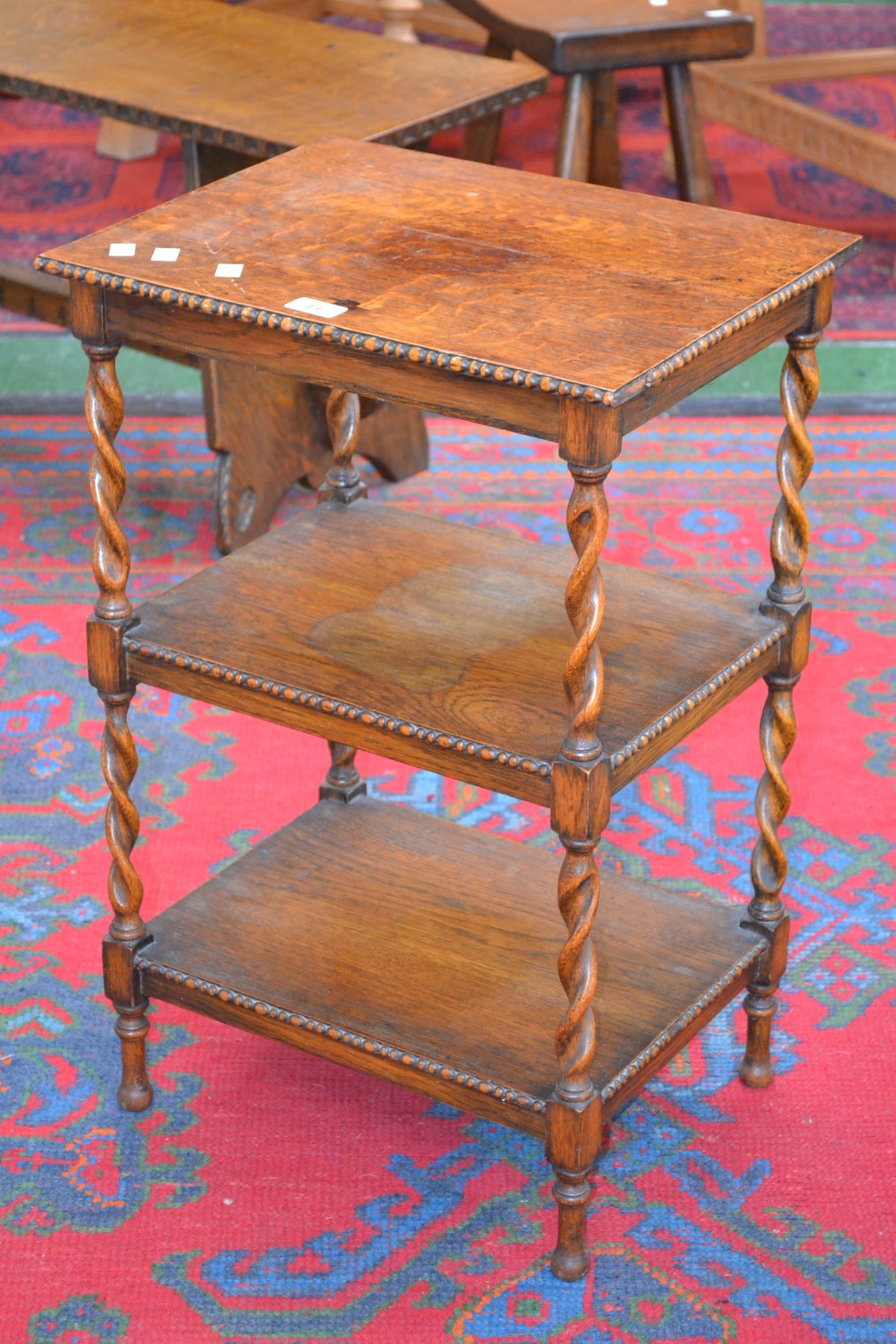 An oak three tier occasional table, barley twist supports, c.1930