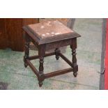An oak stool, rouge marble inlaid stepped top, turned supports.