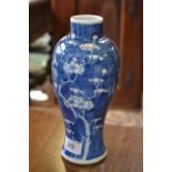 An oriental blue and white inverted baluster vase decorated with flowering prunus.