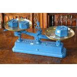 A set of French cast iron weighing scales, painted blue with one 2kg weight and two 1kg weights.