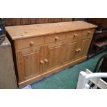 A modern pine four drawer sideboard