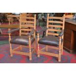 A pair of Monastic oak elbow chairs