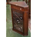 A mahogany wall mounted splay front corner cupboard of small proportions, dentil cornice, astragal