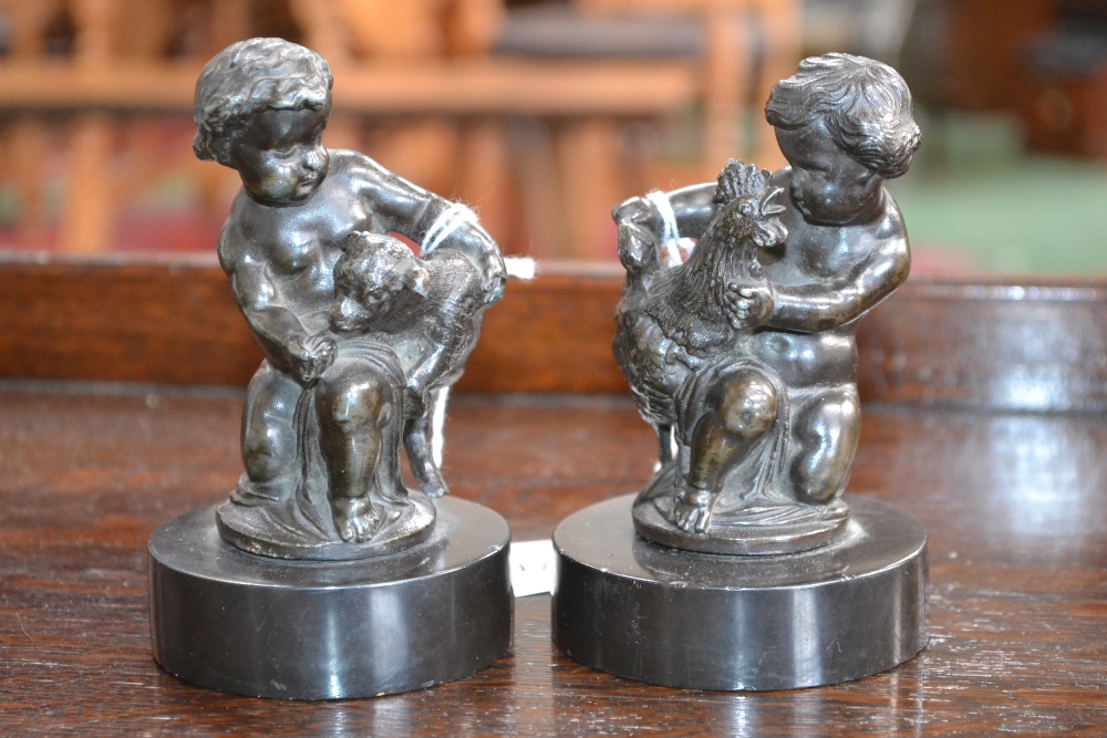 French School (19th century), a pair of dark patinated bronzes, putti with a cockerel and a goat,