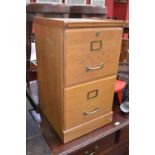 An oak two drawer filing cabinet