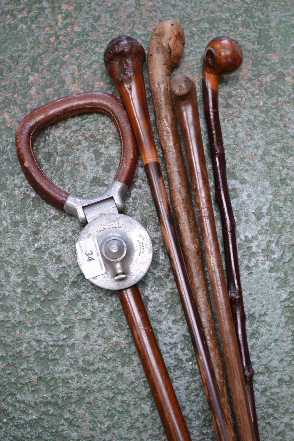 A shooting stick; four walking sticks (5)