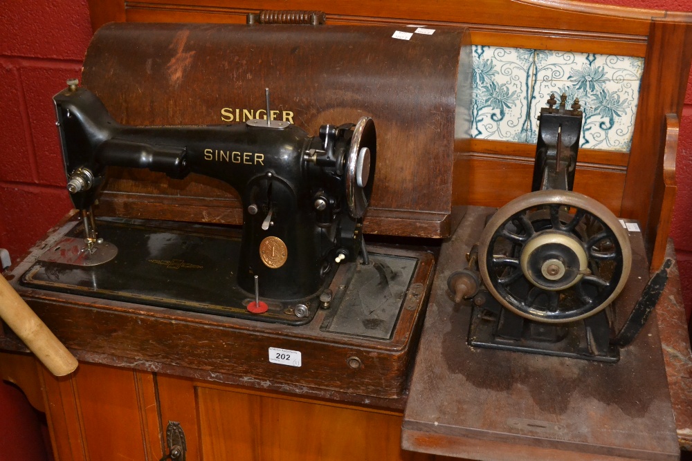 A Singer sewing machine in oak case; another sewing machine