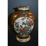 A Japanese Satsuma baluster vase, decorated with three floral panels within chrysanthemums body,