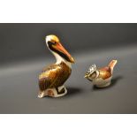 A Royal Crown Derby paperweight pelican, gold stopper; a collectors guild crested tit, 21st