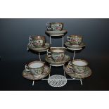 A Cantonese Famille Rose tea service, for six, decorated with figures in a shaped cartouche, the