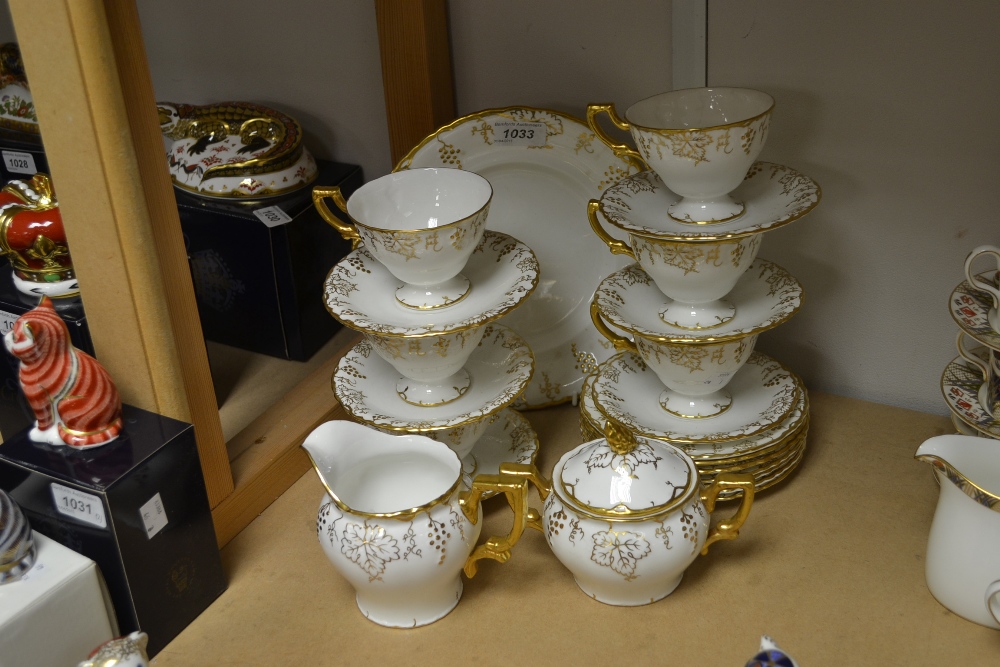 A Royal Crown Derby white glazed vine pattern sucrier and cover, milk jug, bread plate, six