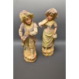 A pair of Continental painted bisque porcelain figures modelled as a grape pickers, Numbered 3365,