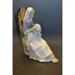 A Lladro figure of a seated lady sewing