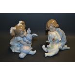 A pair of Nao figures, a boy and girl playing with their soft bunnies, printed and incised marks