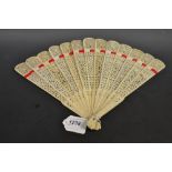 A Cantonese bone brisé thirteen fold fan, the sticks pierced with decorative motifs, strung with
