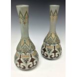A pair of Doulton Silicon Lambeth bottle vases,