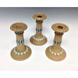 A Royal Doulton harlequin garniture of Silicon ware candlesticks,