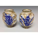 A pair of Royal Doulton globular vases, printed with irises in blue, sponged in gilt, 12.