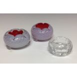 A pair of Webb's glass salts, cased white over red with mica, three ball feet; another,