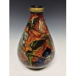 A Doulton Lambeth Faience ovoid vase, painted underglaze with iris flowers on a brown ground,