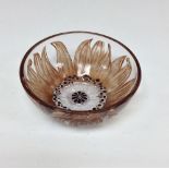 A Lalique bowl, the exterior in relief with flower, washed in brown, the centre picked out in