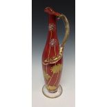 A sang-de-boeuf ewer glass vase, decorated with enamel and gilt flowers, glass snake handle, 22cm