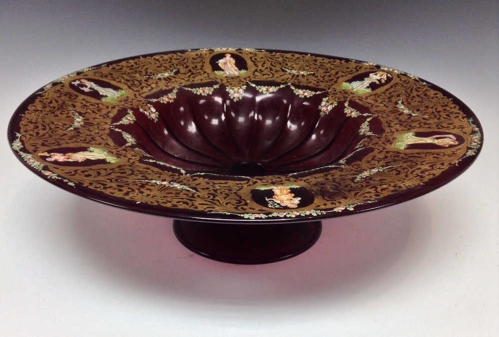 A Bohemian ruby glass pedestal centre bowl, fluted dish, the deep sides with six oval cartouches,