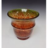 A circular glass vase, cased crystal over mottled green and orange, flared rim,