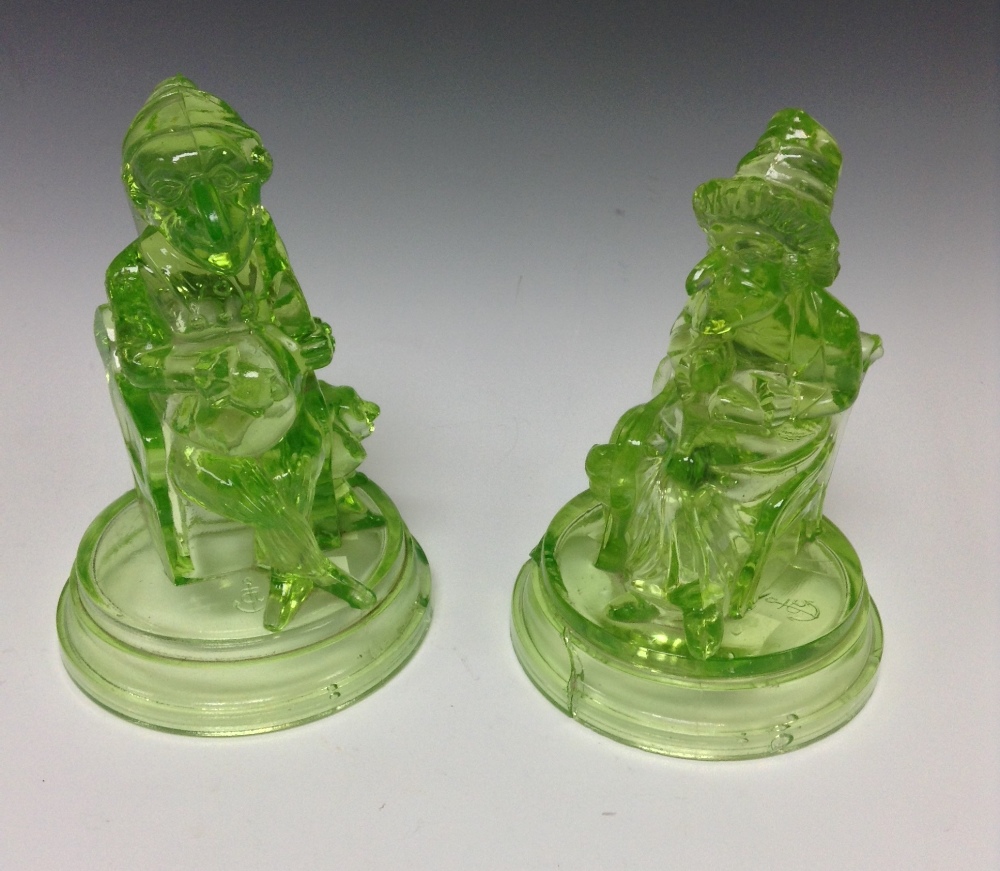 A pair of John Derbyshire uranium glass green pressed figures of Punch and Judy,