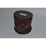 A 20th century German terracotta tobacco jar, in the form of an African boy's head, stamped W.
